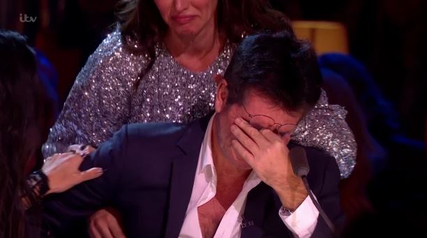  Simon Cowell is comforted by Nicole and partner Lauren Silverman