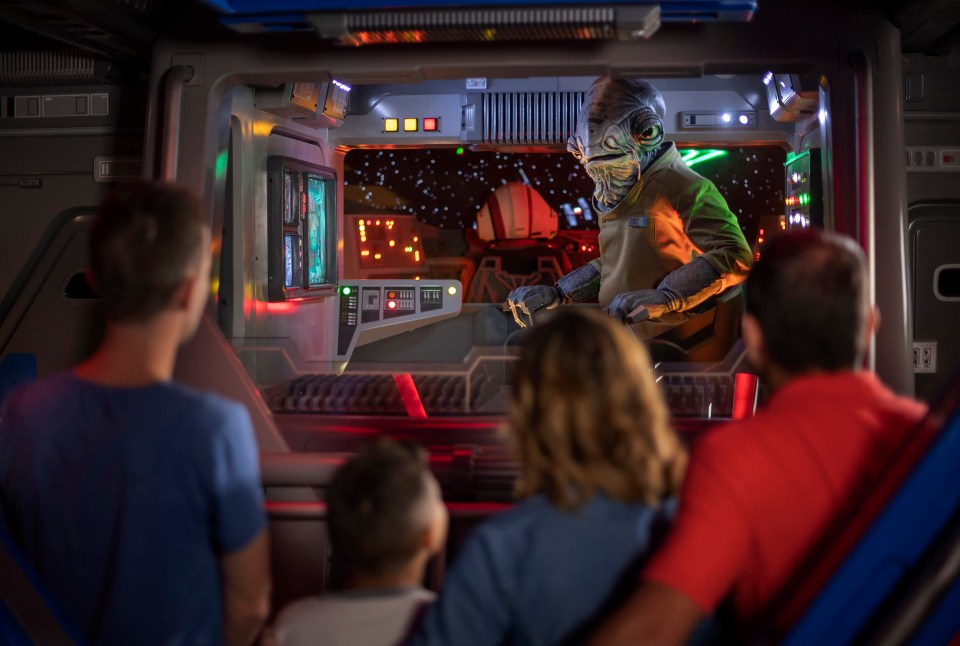  Lieutenant Bek, a Mon Calamari Resistance officer, speaks with guests aboard an Intersystem Transport Ship as they blast off Batuu