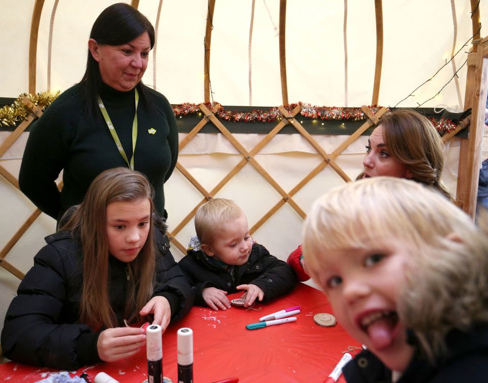 A cheeky child photobombs a snap of Kate