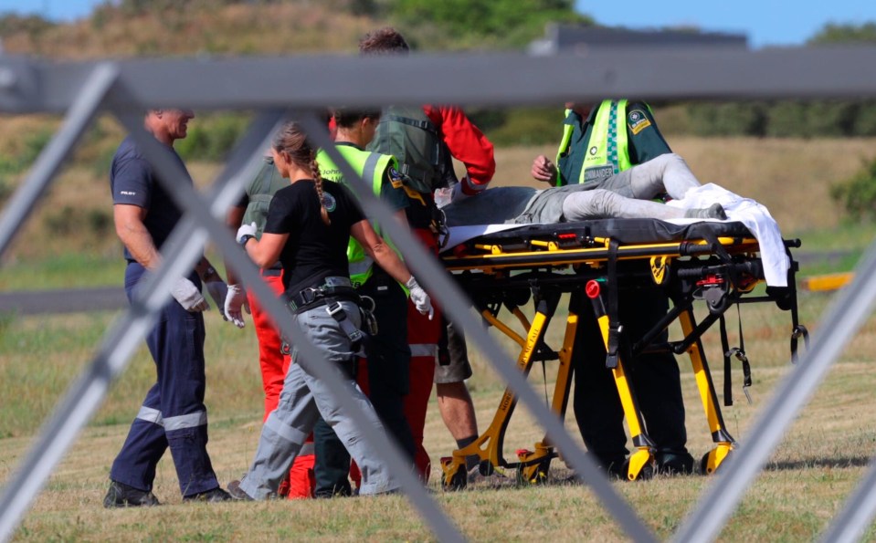  Paramedics tend to an injured person evacuated from the island