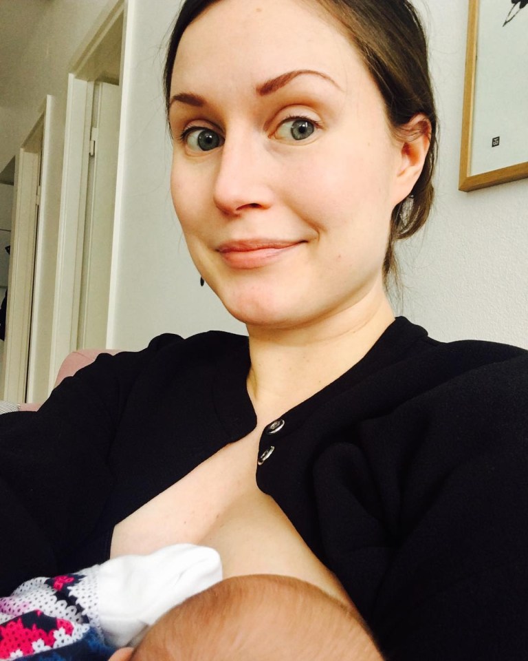 Ms Marin takes a selfie for Instagram as she breastfeeds her baby