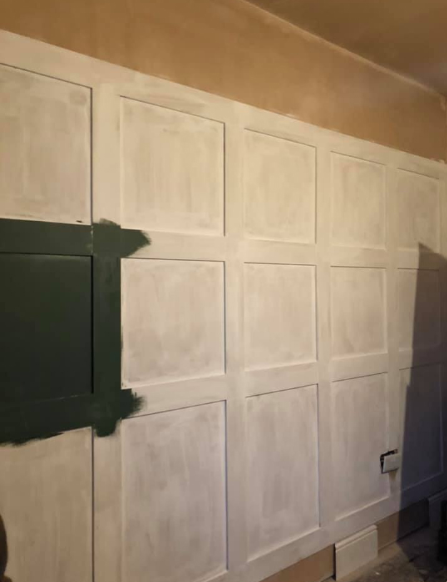 After attaching the wood to the wall, the boards were then painted green