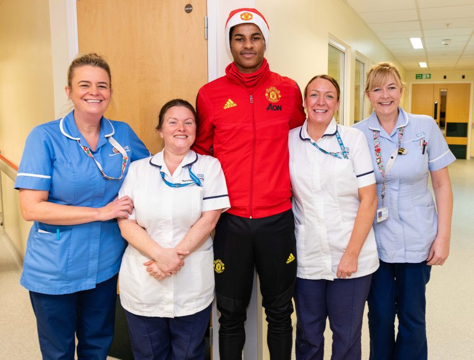  Marcus Rashford poses with members of staff at the hospital