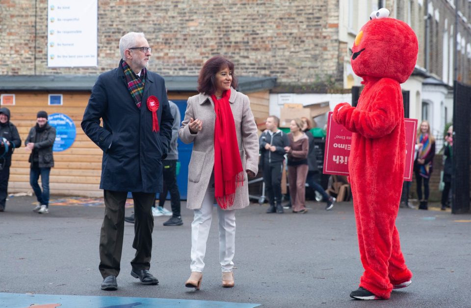  Corbyn is confronted by a protester in an Elmo costume as he casts his vote