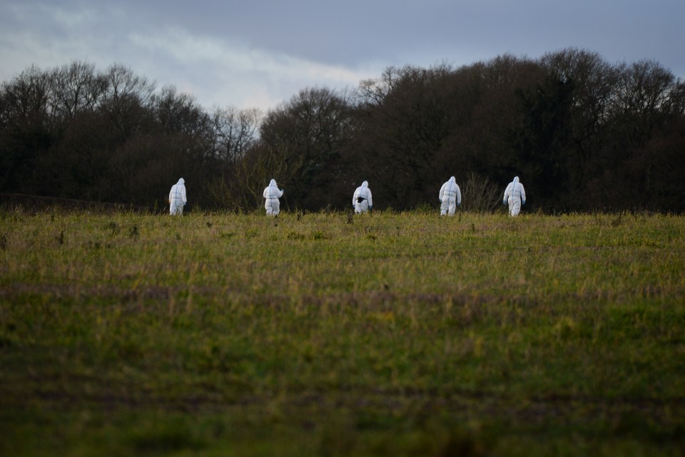  Forensic officers can be seen searching the area for clues