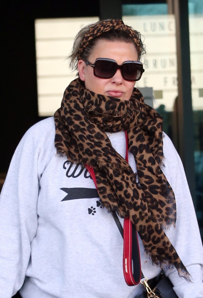  She cut a casual look in a grey jumper and leopard scarf