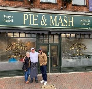  He posed with his mum Sandra outside the famous shop