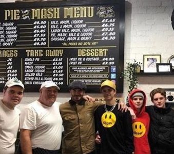  Romeo, Cruz and a pal posed next to the pie and mash menu