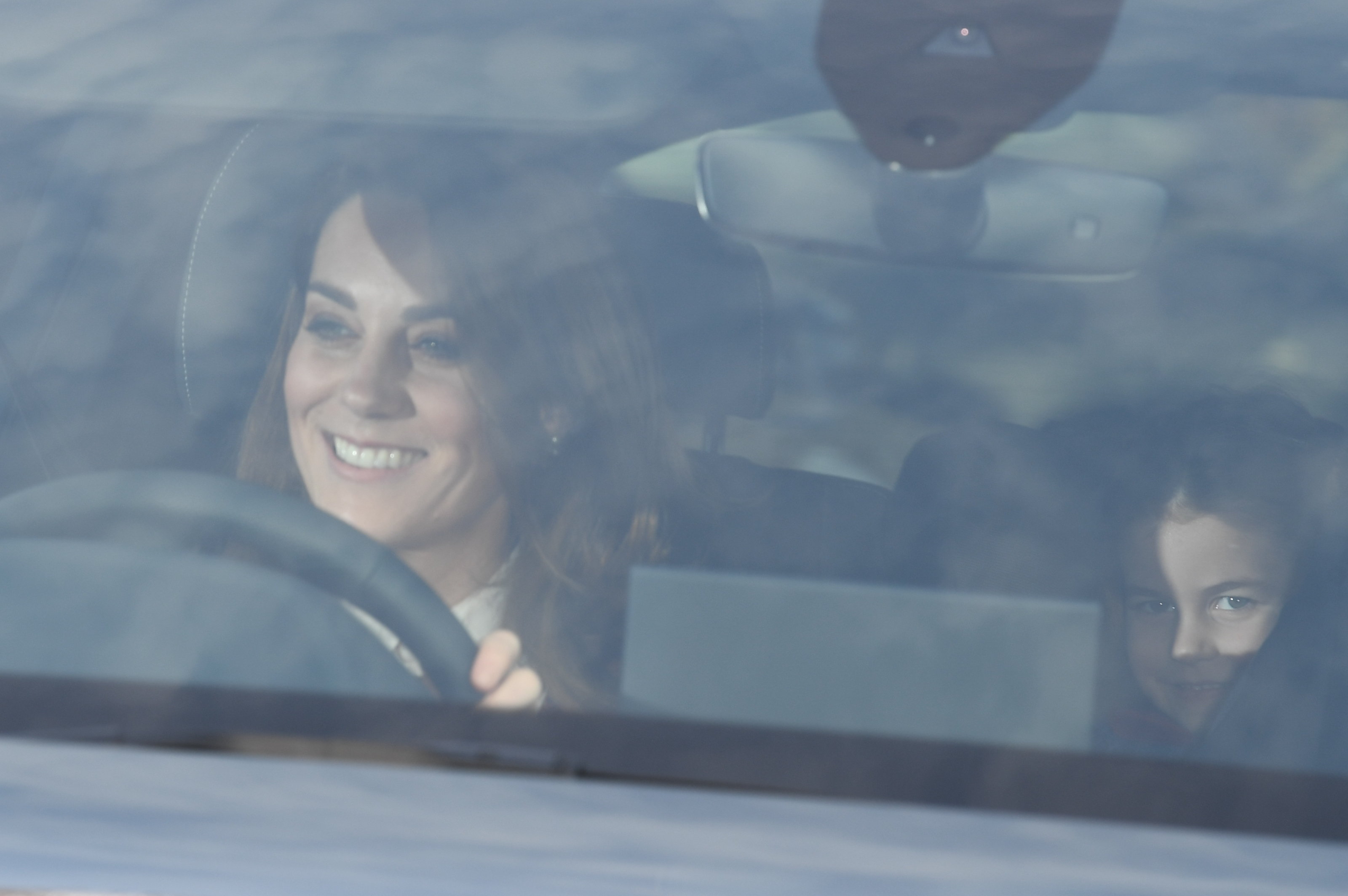 Kate was pictured today with Princess Charlotte and Prince Louis driving to Buckingham Palace for the Queen's Christmas meal for extended family