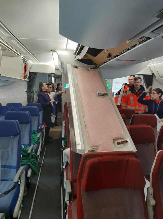  A passenger was injured after a plane luggage bin panel fell from the ceiling