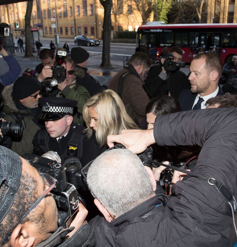  Police had to push their way through photographers as Flack walked into court