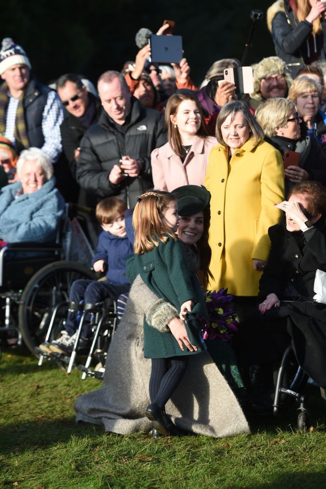  The Duchess of Cambridge, with her four-year-old daughter, chat to the crowds gathered outside the church