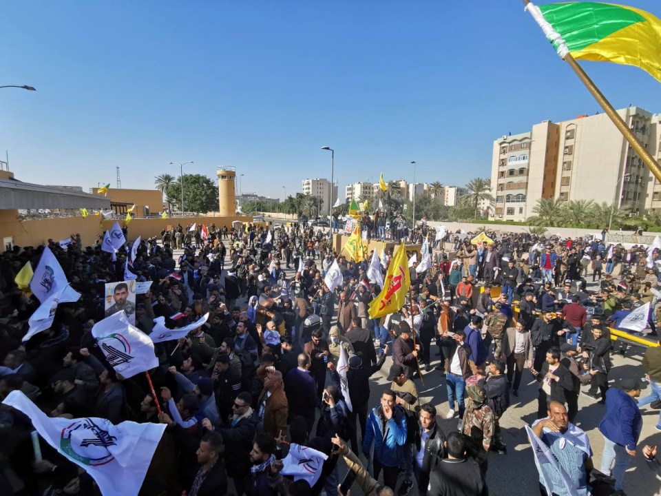  The crowd pushed inside the embassy grounds where security forces used tear gas