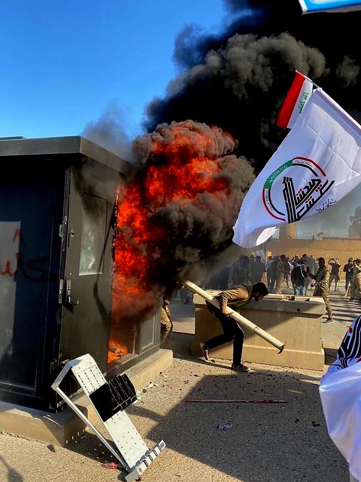  The thugs waved flags of Iran-back militia groups after storming through an outer wall