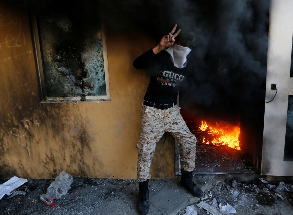  A member of the Hashd al-Shaabi paramilitary forces wearing a Gucci top poses in the US embassy compound