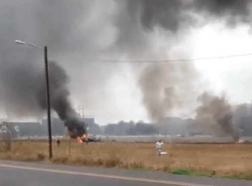  Flames and smoke fill the air after the jet came down just one mile west of Lafayette Airport