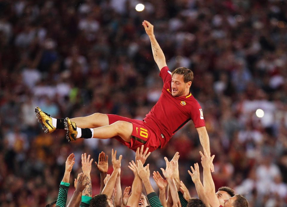  Roma players hold up Francesco Totti after his last match