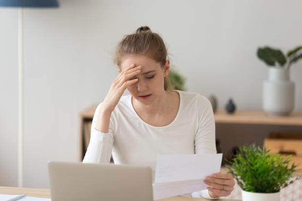 Girl looking worried at letter