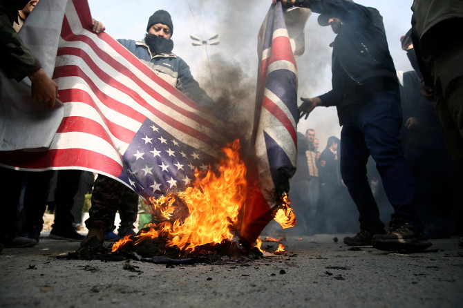  Protesters burn US and UK flags