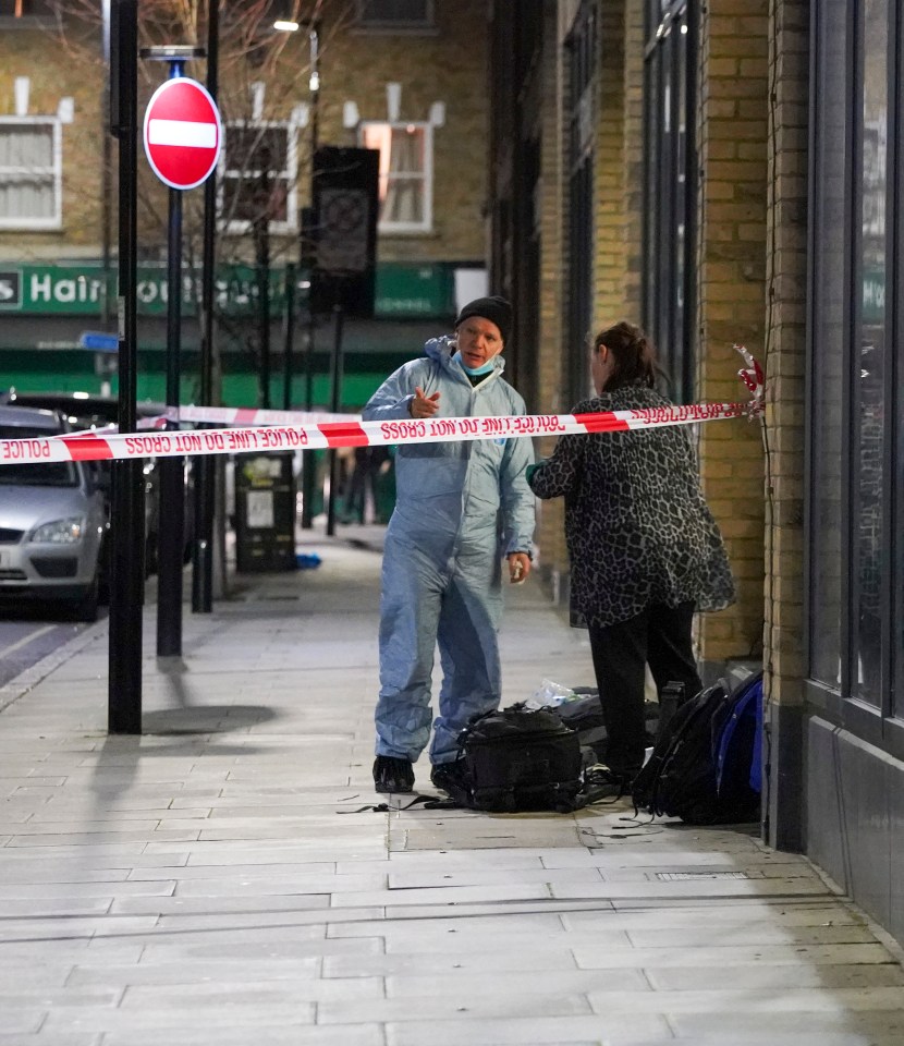  Forensic workers investigating a stabbing in North London