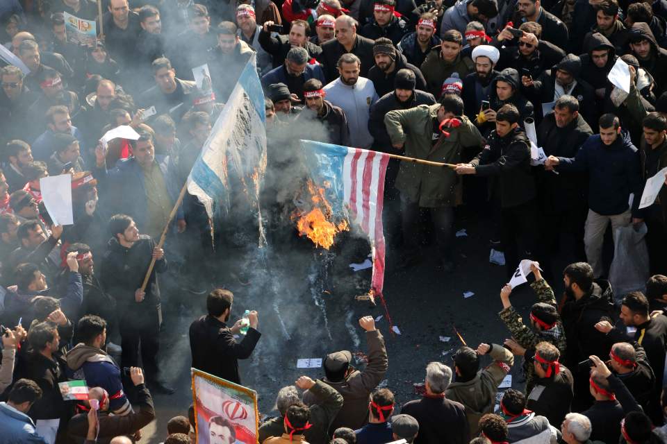  Iranians burn an American flag after the airstrike on General Soleimani