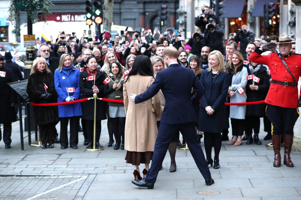  Harry sidesteps around Meghan as they chat to well-wishers clutching Canadian flags