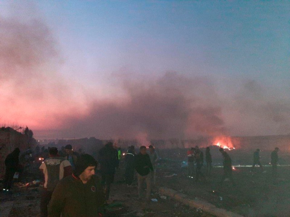  Rescuers at the scene moments after the crash in Tehran