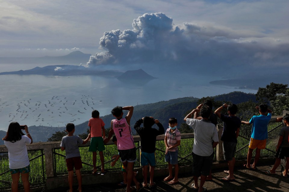 Residents watch from afar as Taal erupts