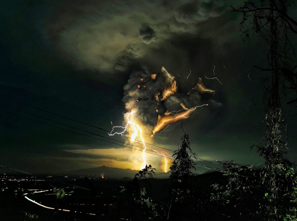 Ash pours into the sky overnight from Taal volcano in the Philippines