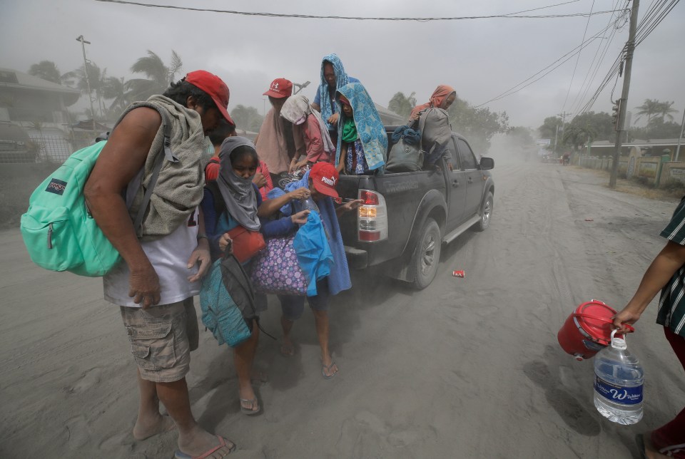 A family flees to safer ground in Lemery, Batangas Province