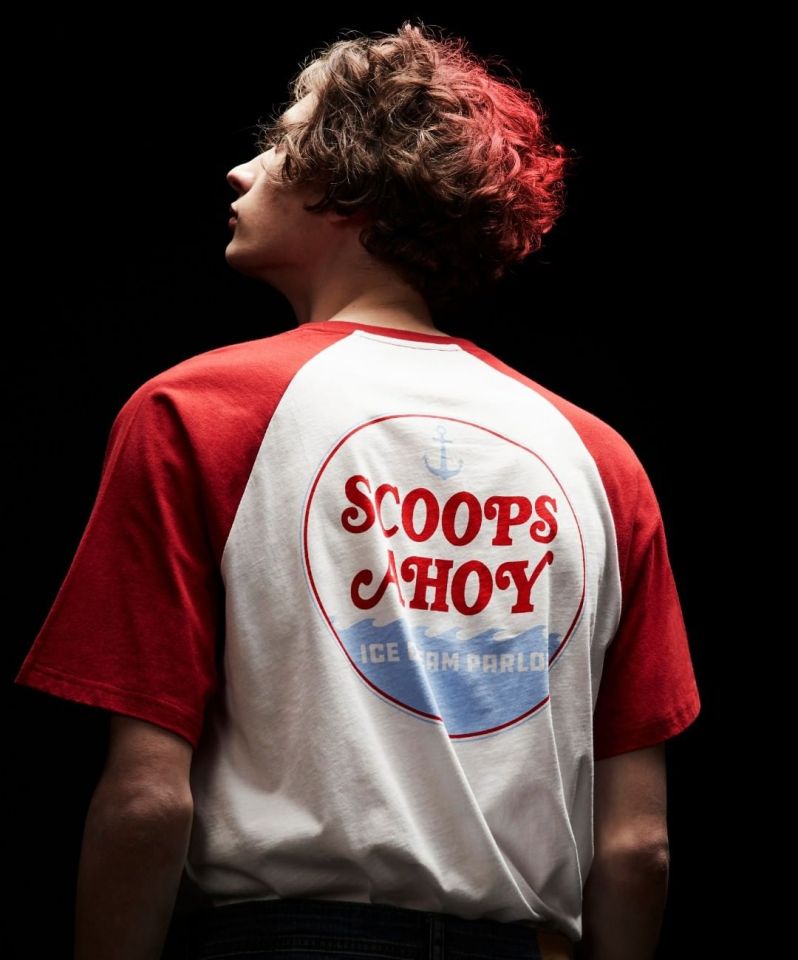 The t-shirt has red capped sleeves and the Scoops Ahoy logo on the back