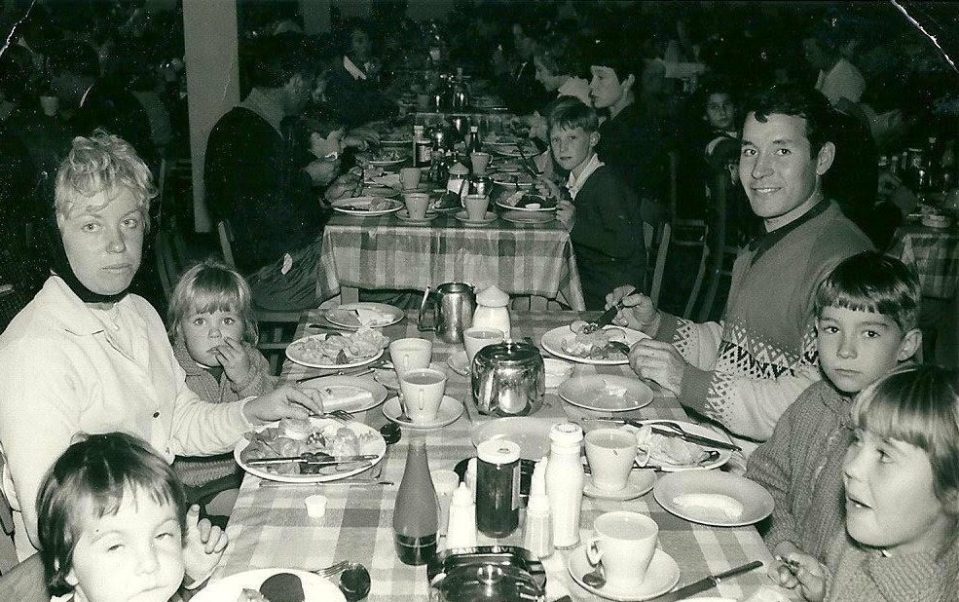  Joy, pictured second left at the back, enjoys a meal with her family