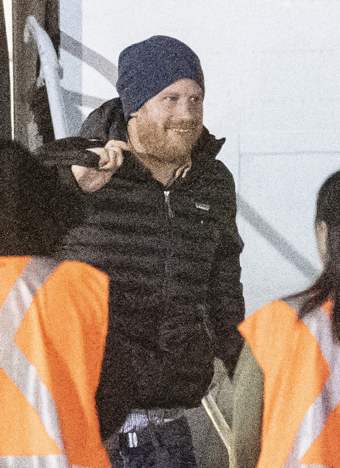 Prince Harry was all smiles as he was pictured departing a plane to join Meghan Markle and baby Archie in Canada