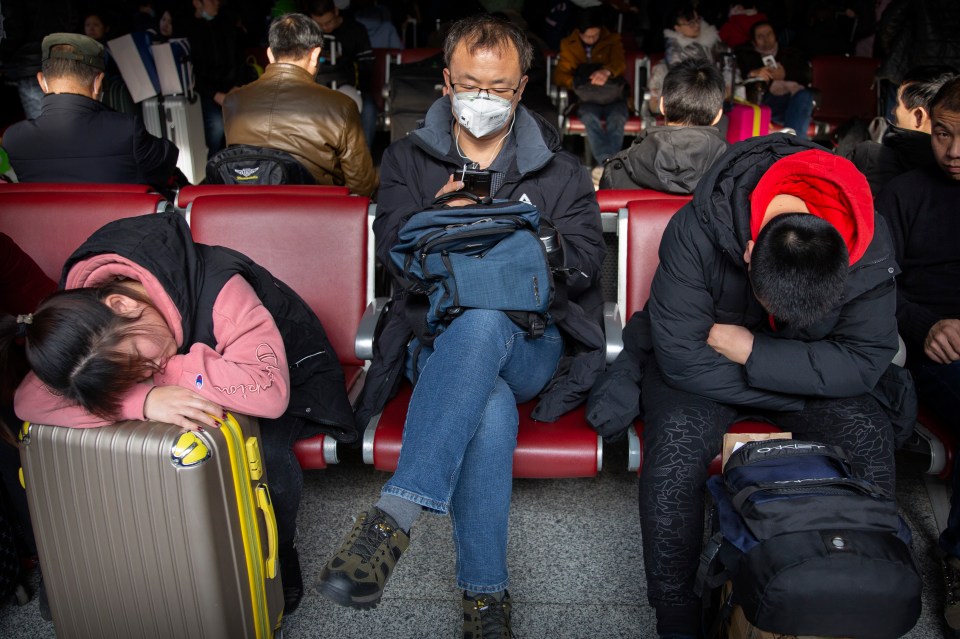  A traveller wears a face mask as he sits in a waiting room at the Beijing West Railway Station