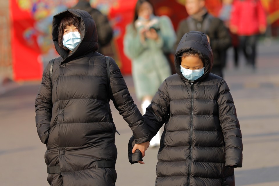  Chinese people wear masks in the street of the capital Beijing