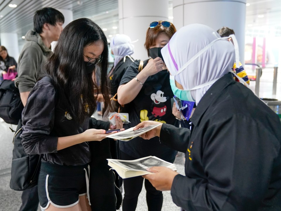 Staff speak to staff at the screening check point