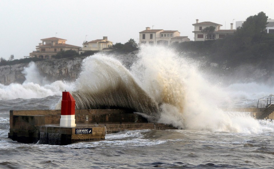  Waves crash into the harbour wall in Manacor, Majorca