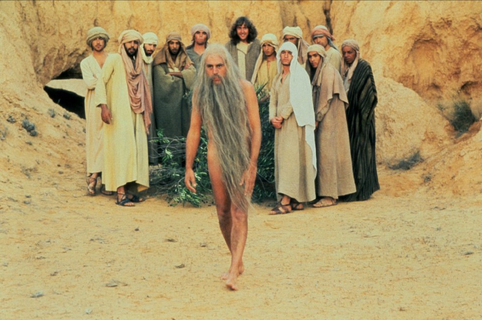  The comedian as a naked hermit who gives away the location of a hiding Brian in Life Of Brian