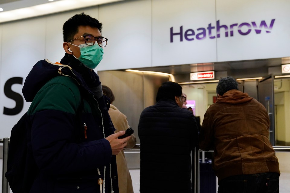  Coronavirus - A passenger arrives wearing a mask at Terminal 4, Heathrow Airport, London