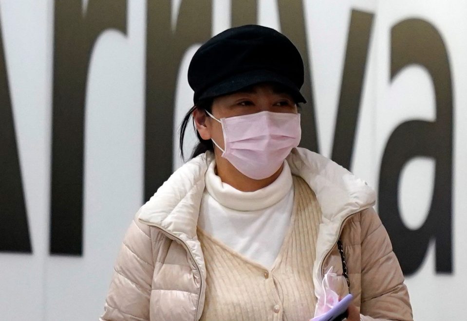  A passenger arrives wearing a mask at Terminal 4, Heathrow Airport, London