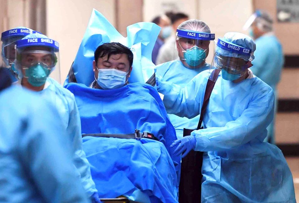  Medics attend to a patient suspected to have been struck down by coronavirus in Hong Kong