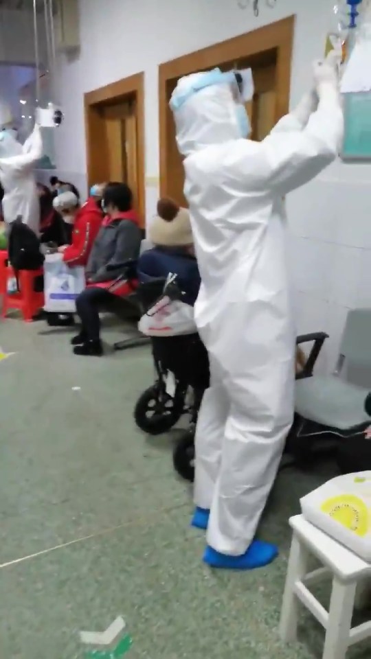 Footage shows staff wearing full-body protective clothing as residents wait to be seen by doctors and nurses