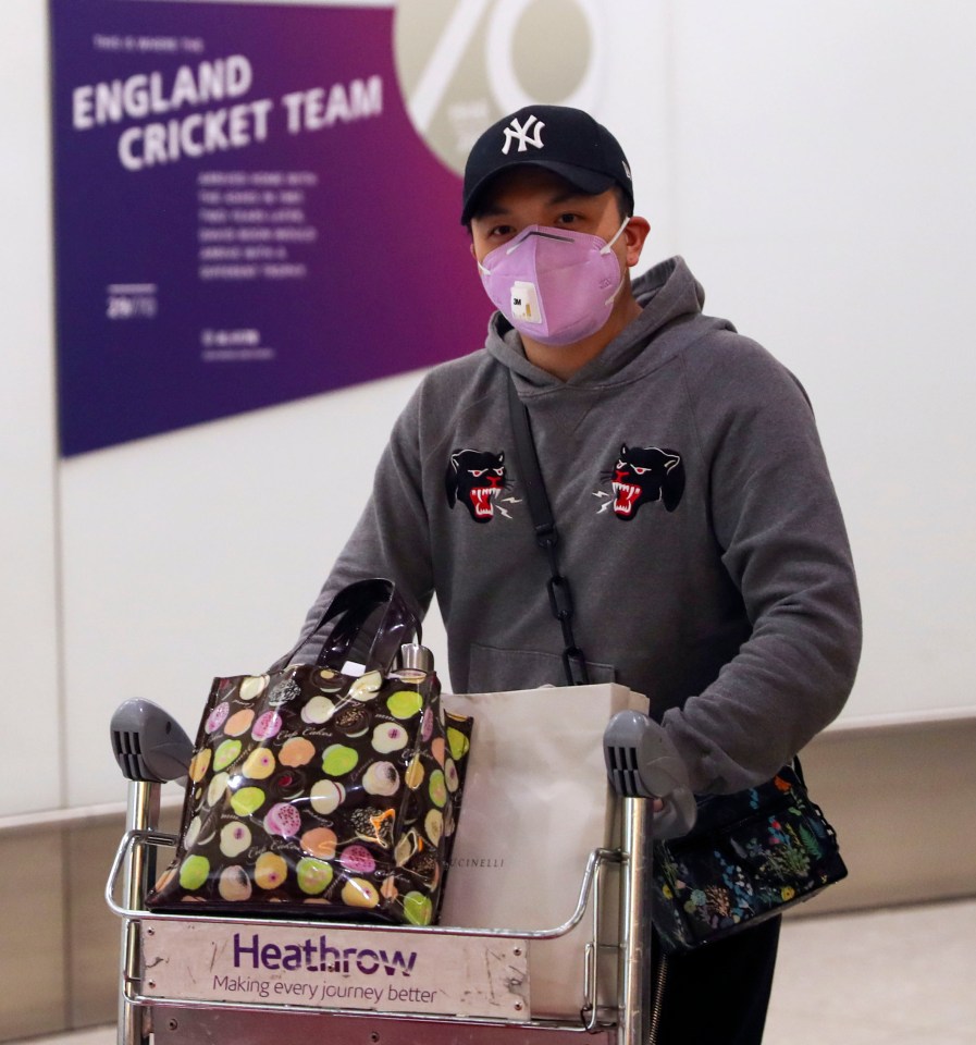  A passenger pushes his luggage through the airport after landing at Heathrow Airport on January 24