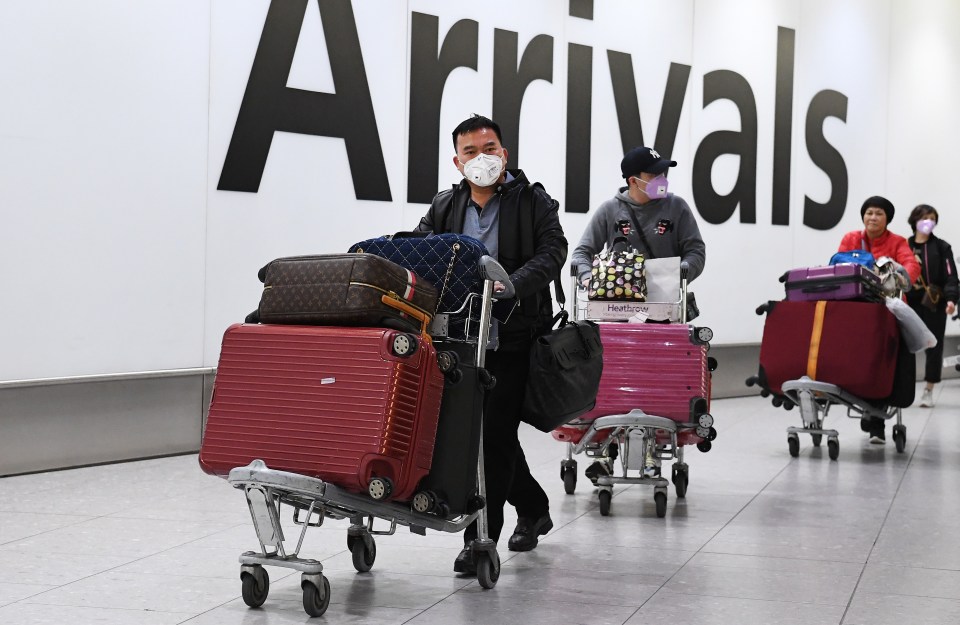  Passengers arriving at Heathrow Airport wearing medical masks