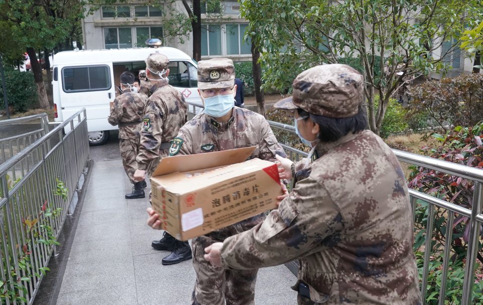  Members of a military medical team carry supplies to a hospital in Wuhan