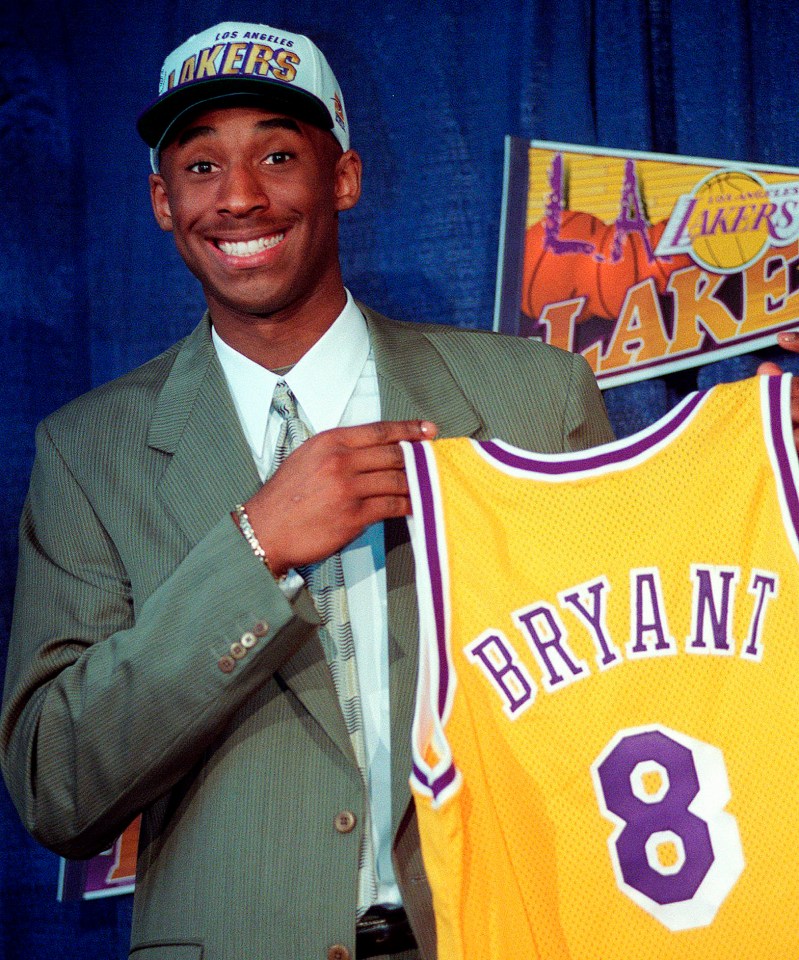  Bryant, 17, jokes with the media as he holds his Los Angeles Lakers jersey in 1996