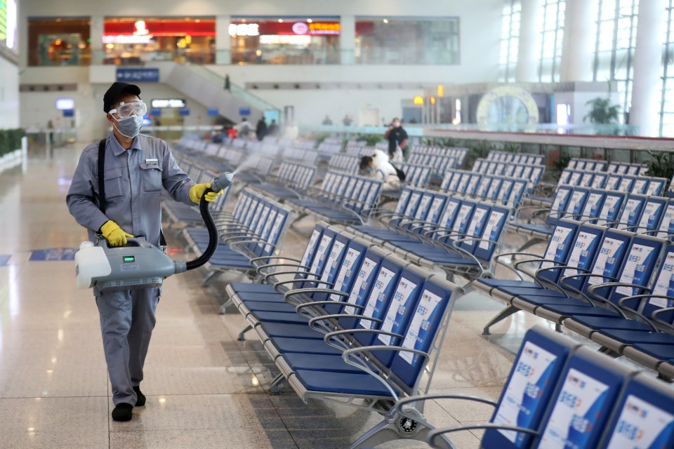  Workers in protective mask disinfects a waiting hall following the outbreak of a new coronavirus at the Nanjing Railway Station