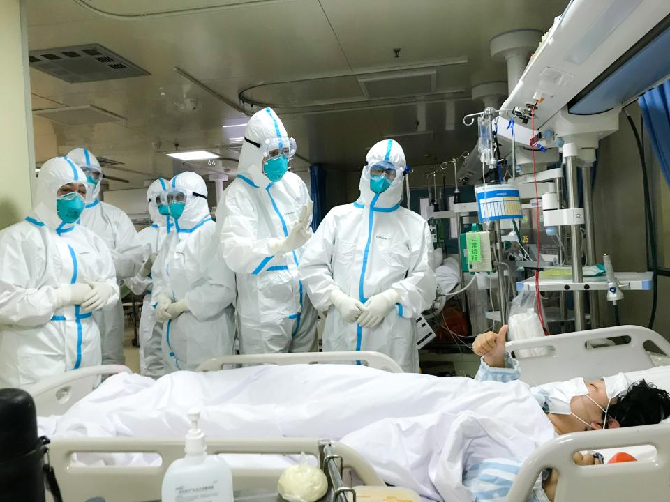  Thumbs up from a patient for well-protected team at a hospital in Wuhan