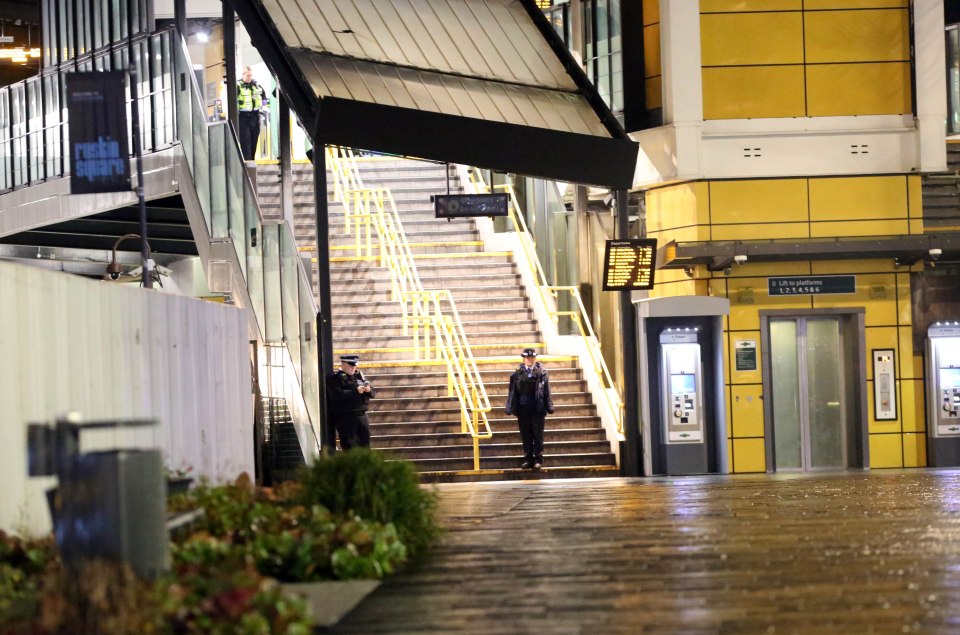  Police officers stand on guard near the station's staircase