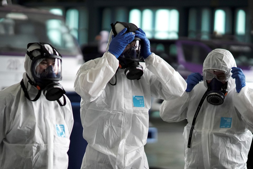 Three people have caught the deadly coronavirus outside of crisis-hit China, image shows Thai Airways workers in hazmat suits as they disinfect a plane